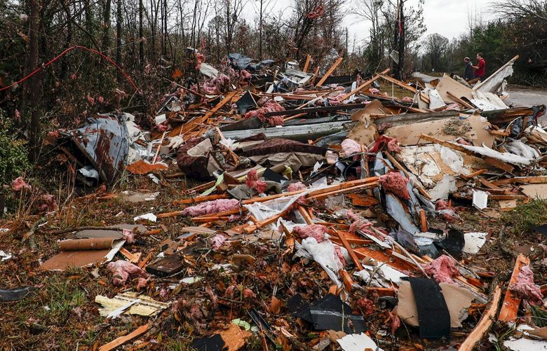National Weather Service members survey damage from a possible tornado that left two dead Wednesday, Nov. 30, 2022, in Flatwood, Ala. (AP Photo/Butch Dill) ALBD104 ALBD104