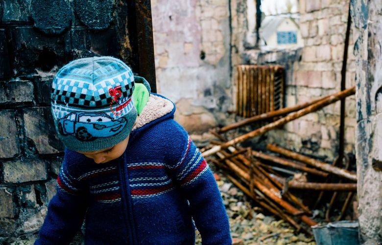 A boy amidst the ruins of his home that was destroyed by a Russian missile, in Bucha, Ukraine on Oct. 24, 2022.