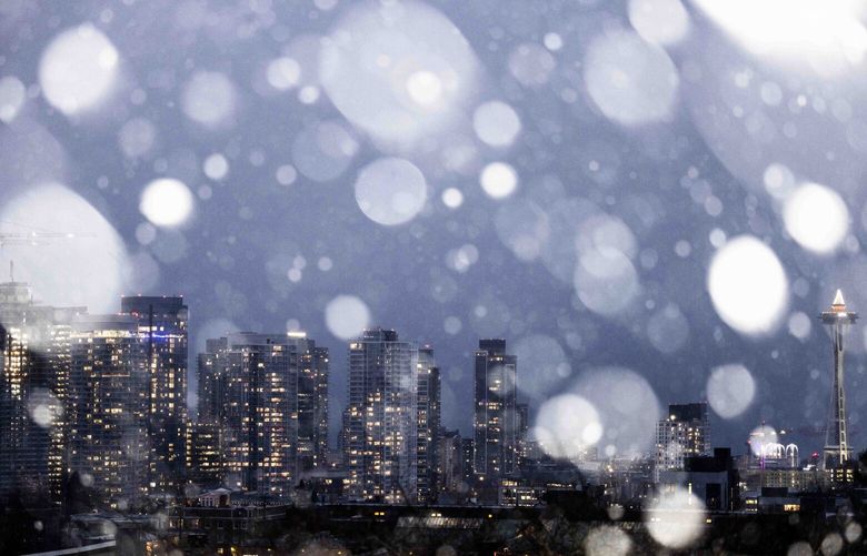 Snow falls over Seattle on Tuesday, Nov. 29, 2022.