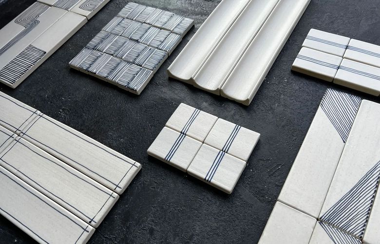 A ceramist, applies fine black lines to her tiles after the first firing. The interest in handmade tile seems to have come at a time when ceramics are having a moment in design. (Charlotte Smith via The New York Times)