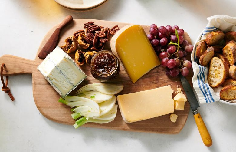A cheese board in New York, Nov. 8, 2022. A few cheeses, some fruits and nuts, and bread or crackers are all you need to build an artfully arranged platter. Food styled by Simon Andrews. (David Malosh/The New York Times)
