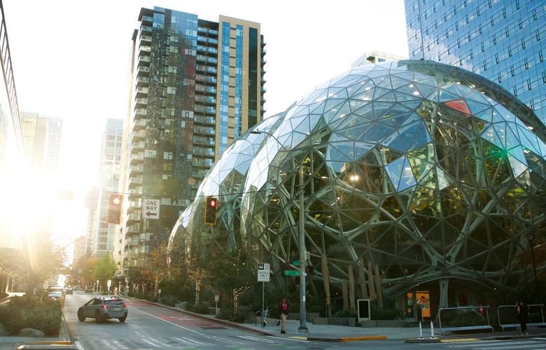Cars drive by Amazon’s Spheres at the corner of Seventh Avenue and Lenora Street in Seattle on Tuesday, Nov. 15, 2022. 222198