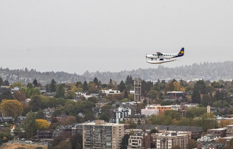 A seaplane flies over Seattle, as seen from atop the Space Needle, on Friday, Oct. 21, 2022.