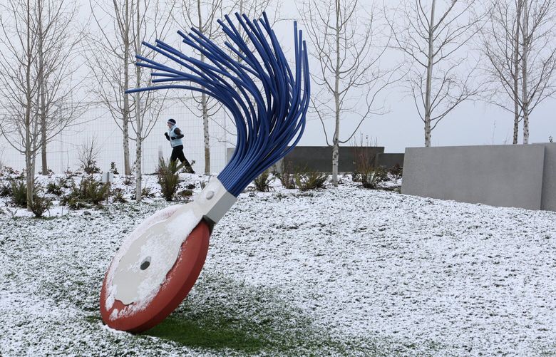 SNOW DUSTING – SEATTLE – 12/14/08
Temperatures in the 30s and a dusting of snow did not stop this runner from darting through the Olympic Sculpture Park on Sunday, and past “Typewriter Eraser, Scale X,” a work by artist Claes Oldenburg and Coosje van Bruggen (cq).
