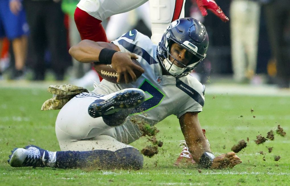 A pair of Seattle Seahawks pull down San Francisco quarterback Alex Smith  (11) by the threads of his jersey Nov. 12, 2007 during a NFL football game  at Qwest Field in Seattle