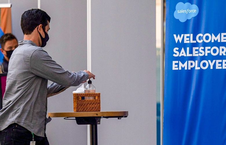 A worker uses hand sanitizer before entering the SalesForce.com Inc. Tower in San Francisco, California, U.S., on Tuesday, Oct. 5, 2021. About 21% of San Francisco areas office workers had returned as of Sept. 22, according to Kastle Systemsa figure that is little changed since the summer and the lowest among 10 U.S. metro areas. 775720720