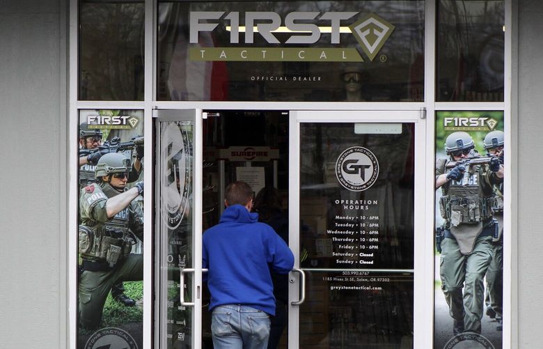 FILE – A man enters a gun shop in Salem, Ore., on Feb. 19, 2021. Voters in Oregon passed one of the nation’s strictest gun control laws, but the new permit-to-purchase mandate is facing a legal challenge with days to go before it takes effect. A federal judge in Portland will hear oral arguments Friday, Dec. 2, 2022, on whether Measure 114, which is scheduled to go into law Dec. 8, violates Americans’ constitutionally protected right to bear arms.   (AP Photo/Andrew Selsky, File) LA401 LA401