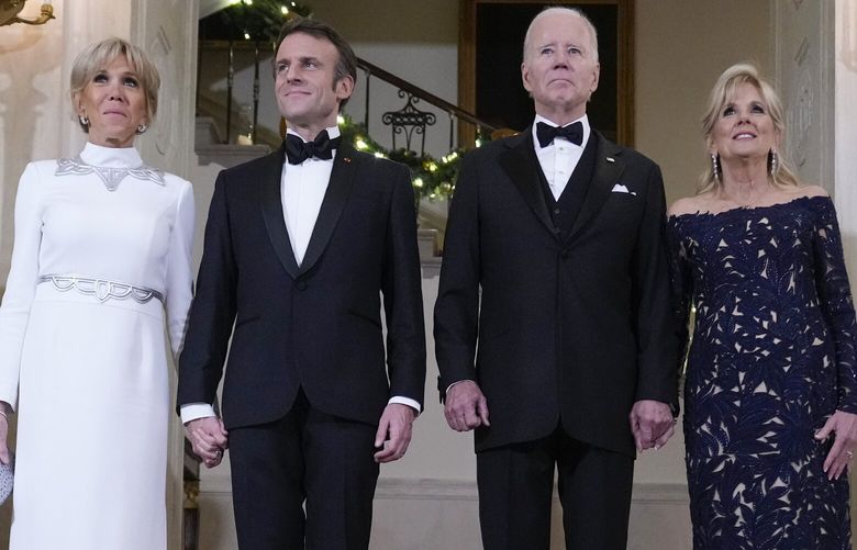 President Joe Biden and first lady Jill Biden pose for a photo with French President Emmanuel Macron and his wife Brigitte Macron in Grand Foyer of the White House before a State Dinner in Washington, Thursday, Dec. 1, 2022. (AP Photo/Andrew Harnik) DCAH411 DCAH411