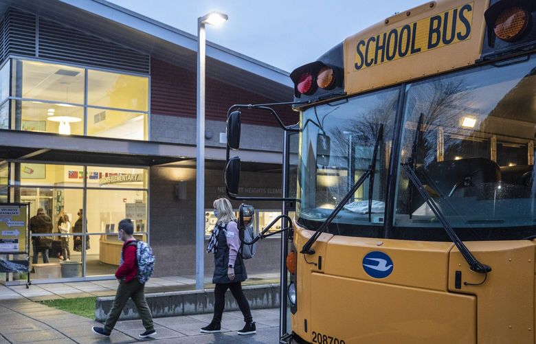 Thursday, January 21, 2021   Students at Newport Heights Elementry School in Bellevue are escorted into school for the first day of expanded in-person instruction.    216175