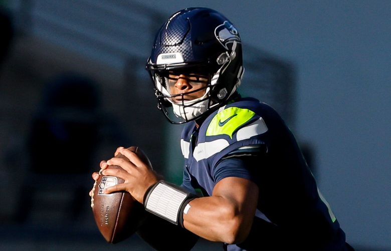 Seattle Seahawks quarterback Geno Smith moves up in the pocket during the first quarter. 222269