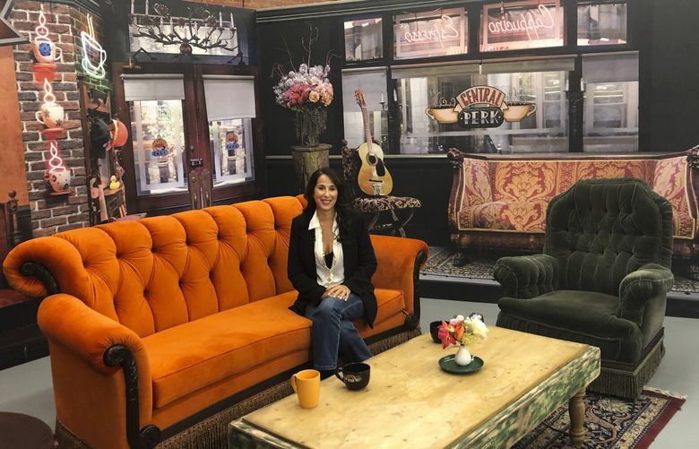 Maggie Wheeler, who played Janice on the NBC sitcom “Friends,” poses for photos in a replica of the Central Perk set, at the New York City Pop-Up experience in New York, Sept. 5, 2019. NYET511