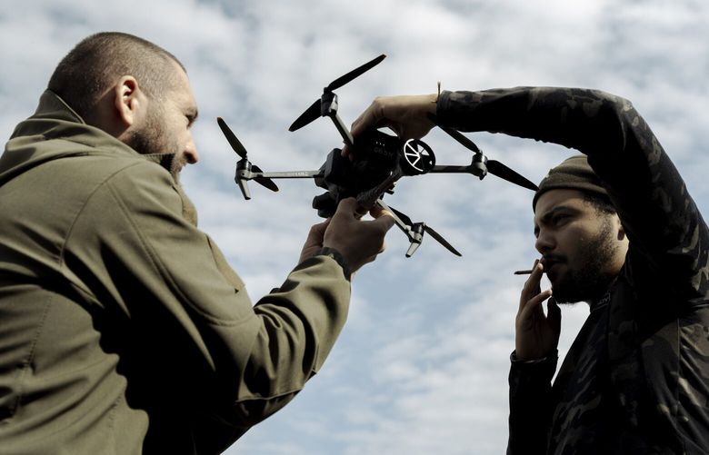 Volunteers learn how to operate a Mavic drone in Ukraine’s Kharkiv region on Sept. 26. MUST CREDIT: Photo for The Washington Post by Sasha Maslov