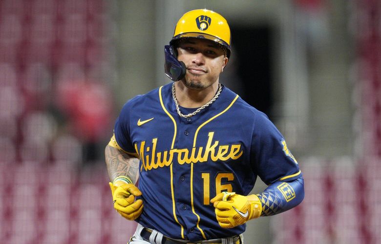 FILE – Milwaukee Brewers’ Kolten Wong runs during a baseball game against the Cincinnati Reds, Sept. 22, 2022, in Cincinnati. Wong is staying in Milwaukee as the Brewers have picked up the $10 million 2023 team option on the veteran second baseman. (AP Photo/Jeff Dean, File)