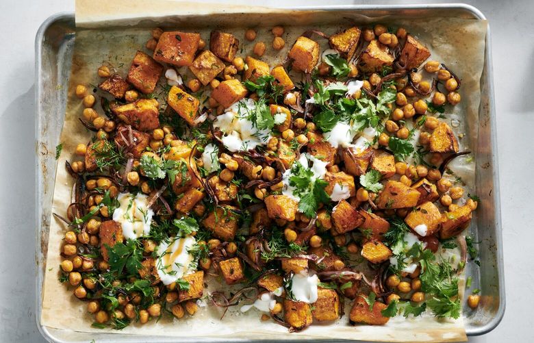 Roasted honey nut squash and chickpeas with hot honey in New York, Nov. 10, 2022. Crunchy spiced chickpeas complement roasted cubes of squash in this sheet-pan meal. Food styled by Simon Andrews. (David Malosh/The New York Times) XNYT21 XNYT21