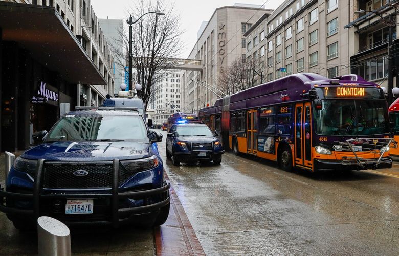 3rd Ave downtown Seattle – Amazon and others moving away from the area – 031422
Two Seattle Police Department vehicles and a mobile precinct van idle along 3rd Ave between Pike and Pine as busses pass by Monday, March 14, 2022 in downtown Seattle, Wash. 219860
