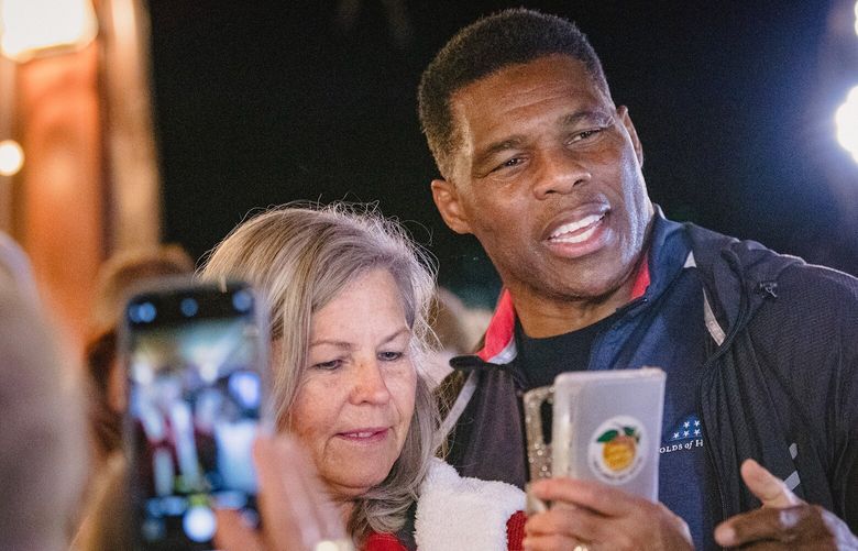 Herschel Walker, the Republican candidate in Georgia’s Senate runoff, greets guests  during a campaign event in Cumming, Ga. on Monday, Nov. 28, 2022. Walker’s performance in the final days of the runoff campaign has Republicans airing frustrations. But no one is counting him out yet. (Dustin Chambers/The New York Times) XNYT137 XNYT137