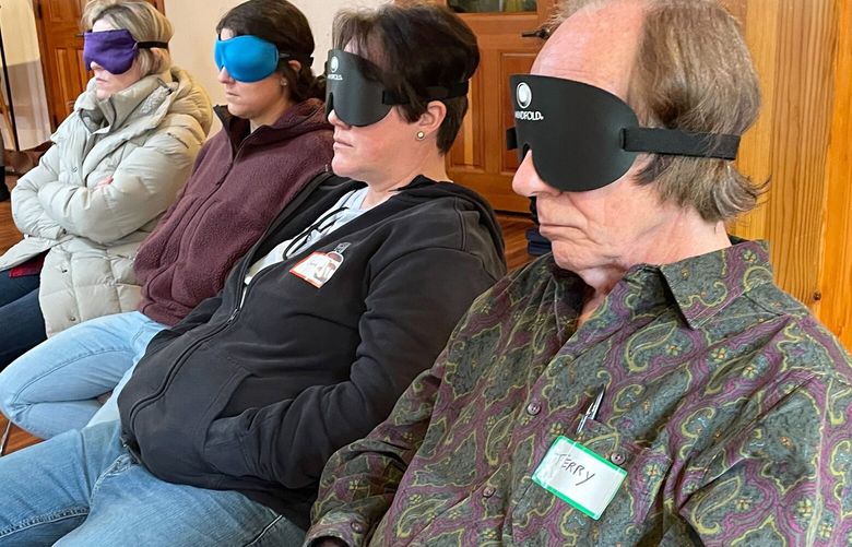 Students at Inner Trek put on eye masks and listen to soft music during a guided meditation in Oregon on Friday, Dec. 2. These future guides or facilitators will be able to legally administer psilocybin to clients after 120 hours of training, 40 hours of practicum, and a state exam. (Esmy Jimenez/The Seattle Times)