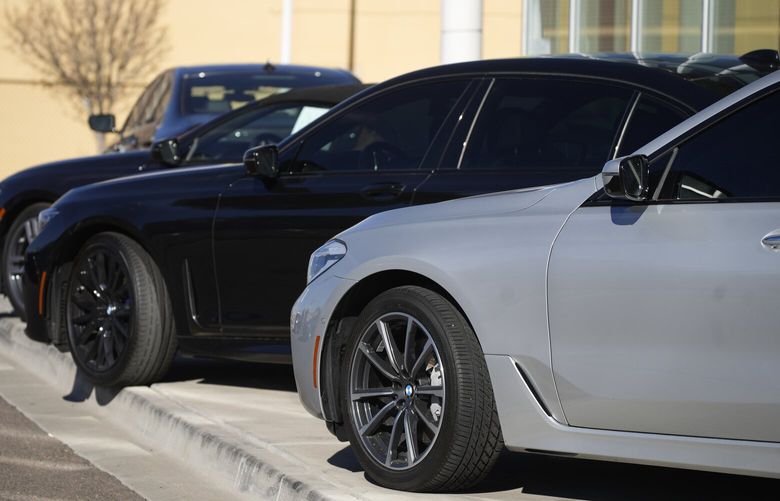 Used sedans sit Thursday, Nov. 25, 2022, outside a BMW dealership in southeast Denver. (AP Photo/David Zalubowski)