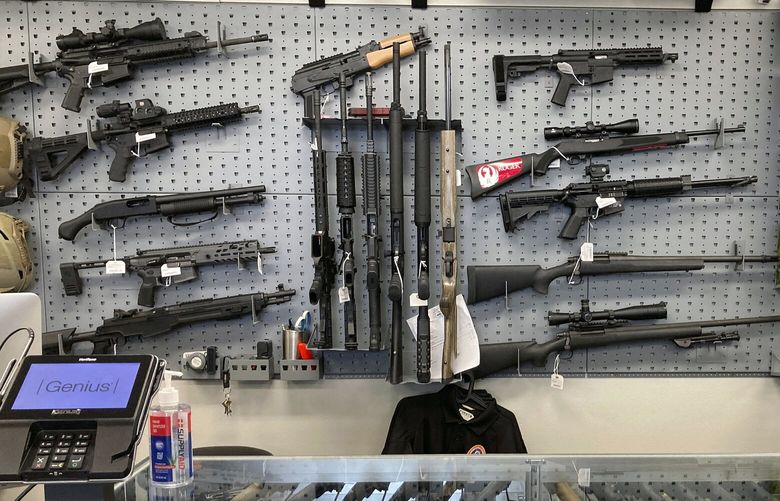 FILE – Firearms are displayed at a gun shop in Salem, Ore., on Feb. 19, 2021. Voters in Oregon passed one of the nation’s strictest gun control laws, but the new permit-to-purchase mandate is facing a legal challenge with days to go before it takes effect. A federal judge in Portland will hear oral arguments Friday, Dec. 2, 2022, on whether Measure 114, which is scheduled to go into law Dec. 8, violates Americans’ constitutionally protected right to bear arms.  (AP Photo/Andrew Selsky, File)