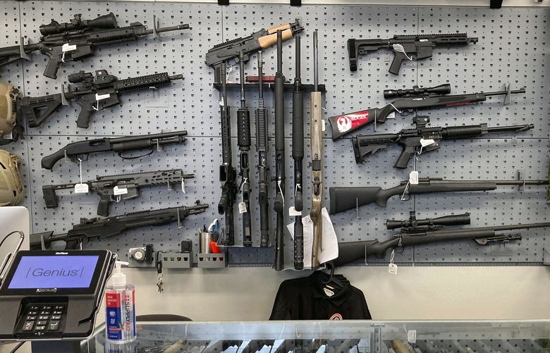 FILE – Firearms are displayed at a gun shop in Salem, Ore., on Feb. 19, 2021. Voters in Oregon passed one of the nation’s strictest gun control laws, but the new permit-to-purchase mandate is facing a legal challenge with days to go before it takes effect. A federal judge in Portland will hear oral arguments Friday, Dec. 2, 2022, on whether Measure 114, which is scheduled to go into law Dec. 8, violates Americans’ constitutionally protected right to bear arms. (AP Photo/Andrew Selsky, File)