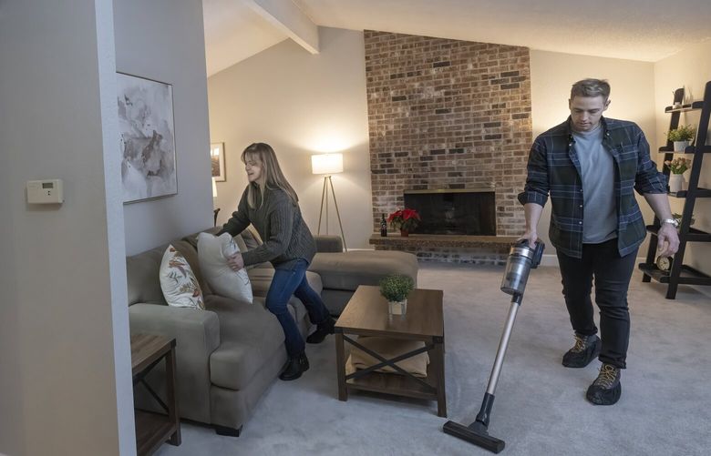 Jen Cameron, (l) managing broker at The Agency and her business partner, broker James Campbell, add final touches to a home they have had listed on the market since mid-October. Shot Friday, December 2, 2022. The housing market is still cooling, particularly on the Eastside.
222378