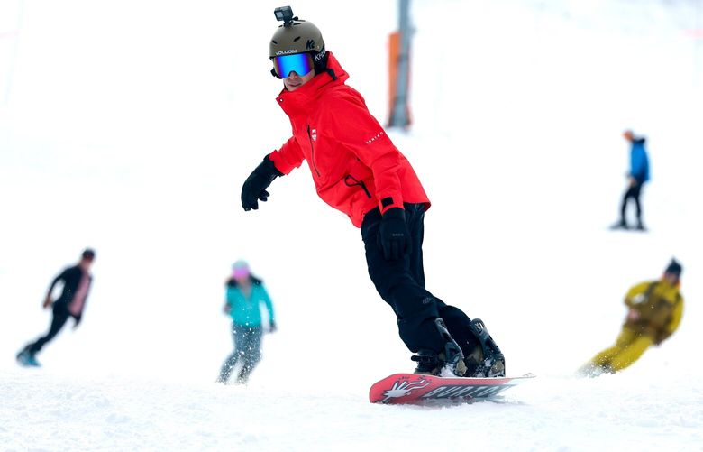 Skiers and snowboarders come back down into the main base area at Crystal Mountain on the first day of general public access Monday, Nov. 21, 2022. 222234