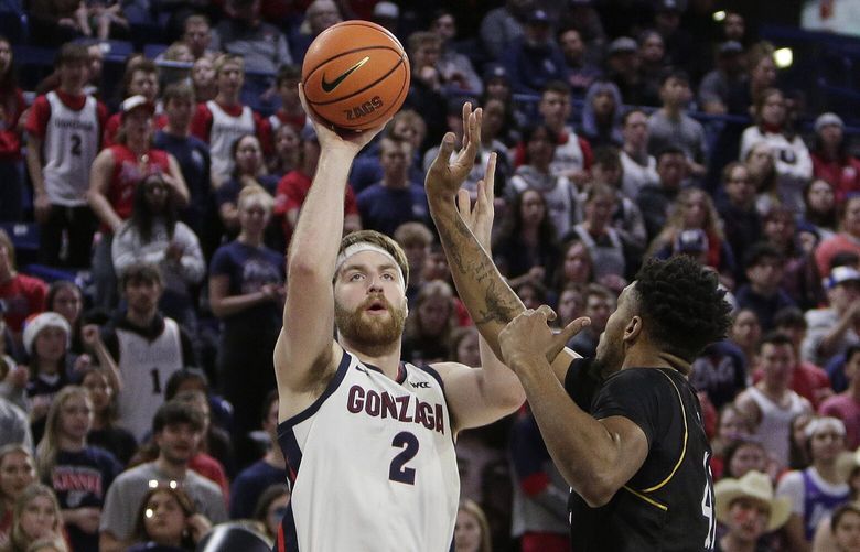 Gonzaga forward Drew Timme, left, shoots while defended by Kent State center Cli’Ron Hornbeak during the first half of an NCAA college basketball game, Monday, Dec. 5, 2022, in Spokane, Wash. (AP Photo/Young Kwak) WAYK106 WAYK106