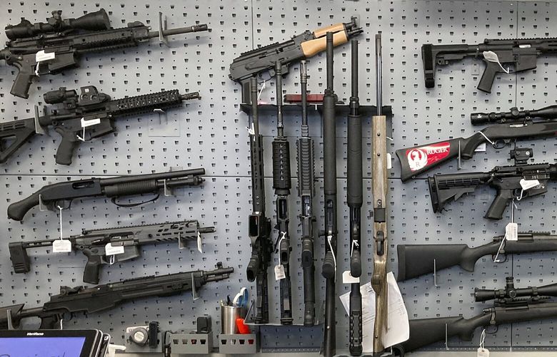 FILE – Firearms are displayed at a gun shop in Salem, Ore., on Feb. 19, 2021. A federal judge in Portland, Ore., ruled Tuesday, Dec. 6, 2022, that a new voter-passed ban on high-capacity gun magazines can go into effect Thursday, Dec. 8, but placed a 30-day hold on a permit-to-purchase requirement after local and state law enforcement agencies said they could not have a permitting system ready in time. (AP Photo/Andrew Selsky, File) NYSS214 NYSS214