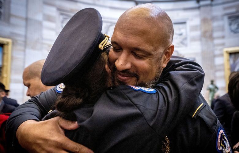 U.S. Capitol Police officer Harry Dunn hugs a colleague after Congressional Leaders hold a Gold Medal Ceremony to honor the U.S. Capitol Police, the Washington D.C. Metropolitan Police and others who protected the Capitol on Jan. 6, 2021. MUST CREDIT: Washington Post photo by Bill O’Leary.