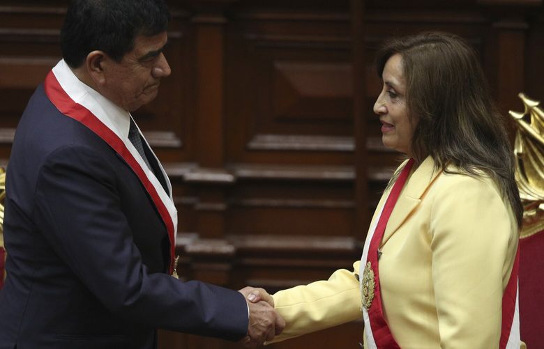 Former Vice President Dina Boluarte, right, shakes hands with Congress President Jose Williams during her swearing-in ceremony to become president at Congress in Lima, Peru, Wednesday, Dec. 7, 2022. Peru’s Congress voted to removeÂ President Pedro CastilloÂ from office Wednesday and replace him with the vice president, shortly after Castillo tried to dissolve the legislature ahead of a scheduled vote to remove him. (AP Photo/Guadalupe Pardo) XLM129 XLM129