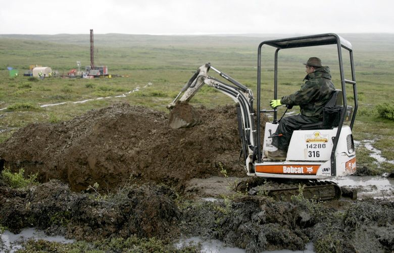 FILE – In this July 13, 2007 file photo, a worker with the Pebble Mine project digs in the Bristol Bay region of Alaska near the village of Iliamma, Alaska. The Trump administration settled a lawsuit Friday, May 12, 2017, over the proposed development of a massive copper and gold deposit near the headwaters of a world-premier salmon fishery in southwest Alaska. (AP Photo/Al Grillo,File) PDX505