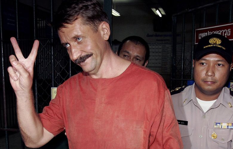 FILE – Alleged Russian arms dealer Viktor Bout gestures as he is taken to a van to be transported back to prison at a criminal court in Bangkok, Thailand on Aug. 11, 2009.  Russia has freed WNBA star Brittney Griner on Thursday in a dramatic high-level prisoner exchange, with the U.S. releasing notorious Russian arms dealer Viktor Bout. (AP Photo/Apichart Weerawong, File) GRI102 GRI102