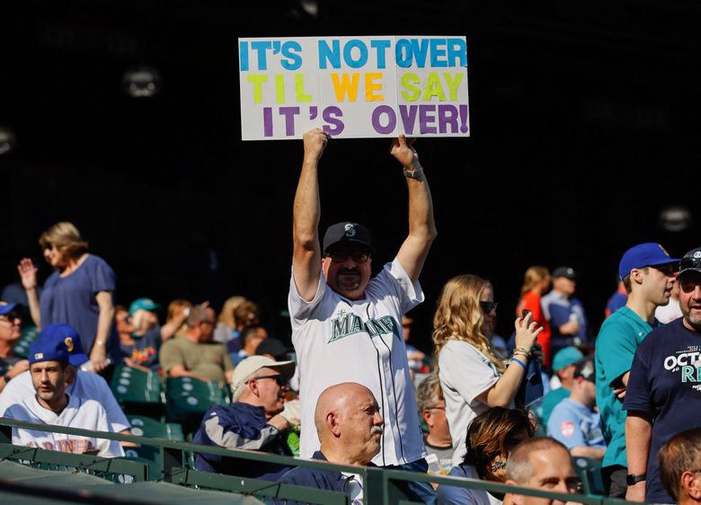 Mariners fan Fred Wist says “It’s not over til we say it’s over!” as the Seattle Mariners take on the Houston Astros for Game 3 of the American League Division Series. (Jennifer Buchanan / The Seattle Times)
