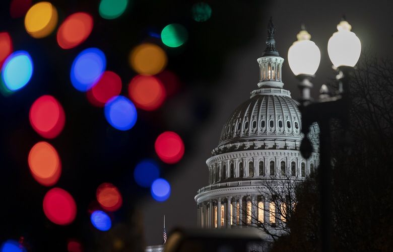 The Capitol is seen amid holiday lights Wednesday evening as the House of Representatives works to approve the Respect for Marriage Act, a bill already passed in the Senate to codify both interracial and same-gender marriage, in Washington, Dec. 7, 2022. (AP Photo/J. Scott Applewhite) DCSA128 DCSA128