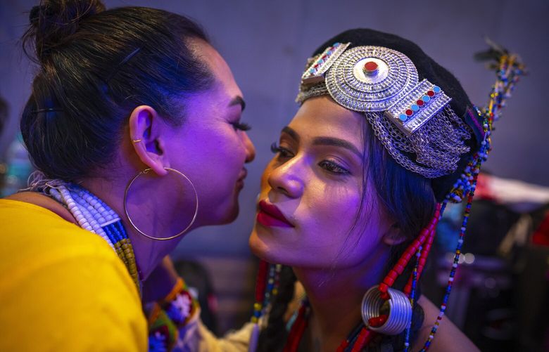 Dione, left, and Mayumi wish each others before the start of the Miss Trans Northeast 22, beauty pageant in Guwahati, India, Wednesday, Nov. 30, 2022. In a celebration of gender diversity and creative expression, a beauty pageant in eastern Indian state of Assam brought dozens of transgender models on stage in Guwahati. Sexual minorities across India have gained a degree of acceptance especially in big cities and transgender people were given equal rights as a third gender in 2014. But prejudice against them persists and the community continues to face discrimination and rejection by their families. (AP Photo/Anupam Nath) GTI109 GTI109