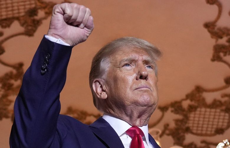 FILE – Former President Donald Trump stands on stage after announcing a third run for president at Mar-a-Lago in Palm Beach, Fla., Nov. 15, 2022. Trump has spent years teasing the prospect of another presidential run. But in the first week since announcing his third bid for the White House, he’s done little to suggest that he’s organizing a traditional campaign. (AP Photo/Andrew Harnik, File) WX201 WX201