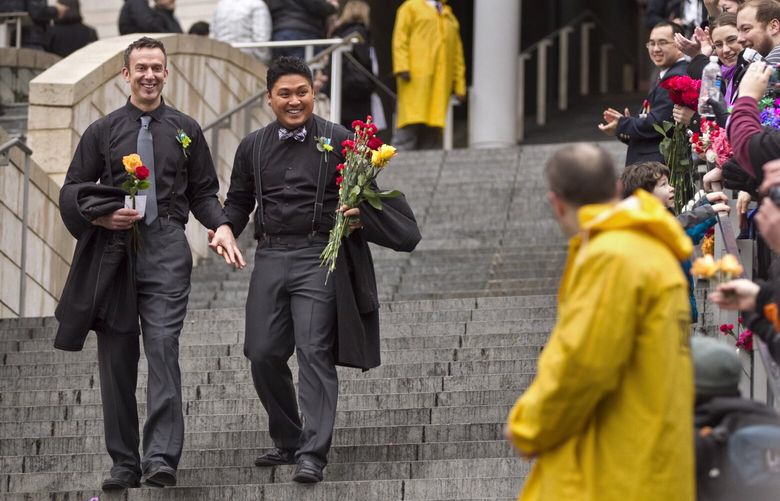 Luke Botzheim, left, 46, and Allan Carandang, 37, of Seattle, walk down the grand staircase outside Seattle City Hall after being married on Sunday, December 9, 2012.

Over 140 couples will be married inside Seattle City Hall Sunday December 9, 2012 for the “Get Married at City Hall” event  following the passage of Referendum 74, which approved a bill legalizing same-sex marriage in the state of Washington.

126362
