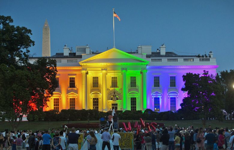 FILE – People gather in Washington’s Lafayette Park to see the White House illuminated with rainbow colors to mark the U.S. Supreme Court’s ruling to legalize same-sex marriage, June 26, 2015. President Joe Biden plans to sign legislation this coming week that will protect gay unions even if the Supreme Court revisits its ruling supporting a nationwide right of same-sex couples to marry. It’s the latest part of Biden’s legacy on gay rights, which includes his unexpected endorsement of marriage equality on national television a decade ago when he was vice president. (AP Photo/Pablo Martinez Monsivais, File) WX463 WX463