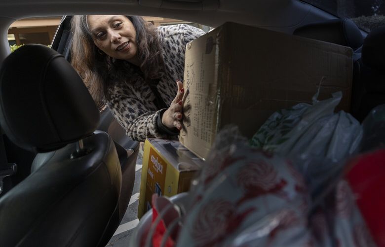 Karlah Ramírez-Tánori, LifeWire services director, loads items in her car that she will be dropping off to clients, Tuesday, December 6, 2022.  Almost 20 years ago, Karlah was a victim of domestic violence with two young children. She fled that relationship with the help of LifeWire, a nonprofit based in Bellevue, focused on helping domestic violence survivors reassemble their lives. She left behind a lucrative life of restaurant and bar ownership and committed to helping other domestic survivors. 