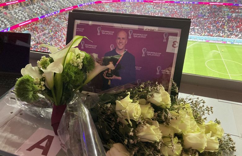 A tribute to journalist Grant Wahl is seen on his previously assigned seat at the World Cup quarterfinal soccer match between England and France, at the Al Bayt Stadium in Al Khor, Qatar, Saturday, Dec. 10, 2022. Wahl, one of the most well-known soccer writers in the United States, died early Saturday Dec. 10, 2022 while covering the World Cup match between Argentina and the Netherlands. (AP Photo/Graham Dunbar) TH401 TH401