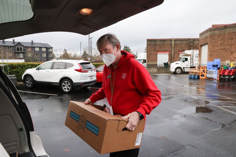 Bill Talbot, social services director for the Seattle White Center Salvation Army Community Center, picks up food at the West Seattle Thriftway. He has been at the center for almost a quarter-century, giving back. (Karen Ducey / The Seattle Times)