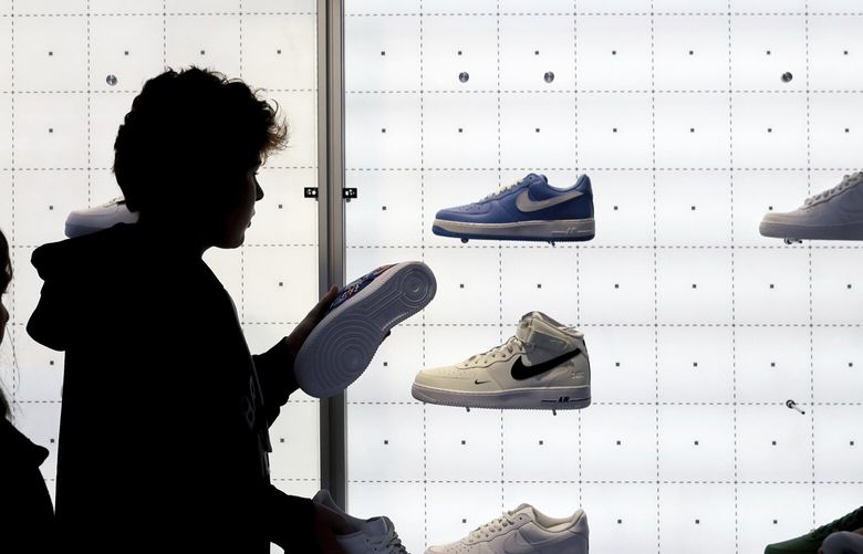 FILE – People shop for shoes in a Nike store on Black Friday, Nov. 25, 2022, in New York. (AP Photo/Julia Nikhinson, File) 
