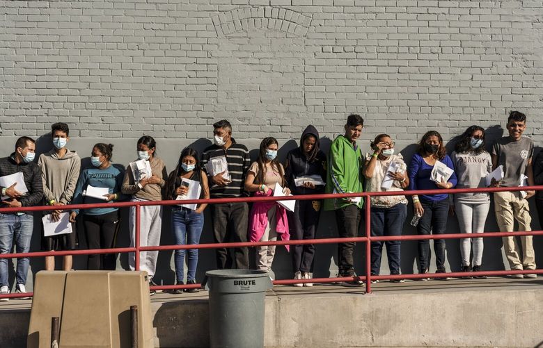 Migrants, mostly from Nicaragua, line up at the entrance of a bus station after being dropped off by immigration authorities in downtown El Paso, Texas on Monday, Dec. 12, 2022. Officials in Texas took steps on Tuesday to all but close an international crossing in El Paso, as state police began conducting commercial vehicle inspections of every truck entering the United States.(Paul Ratje/The New York Times) XNYT98 XNYT98