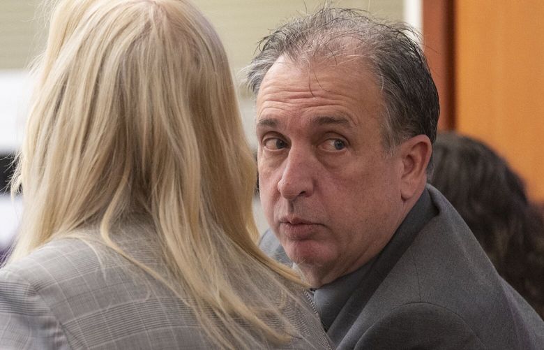 Pierce County Sheriff Ed Troyer looks over his shoulder while talking with his defense attorney Anne Bremner on Monday in Pierce County District Court. A jury on Wednesday acquitted Troyer of false-reporting charges. 