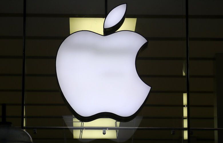 FILE – The Apple logo is illuminated at a store in the city center in Munich, Germany, on Dec. 16, 2020. (AP Photo/Matthias Schrader, File) 