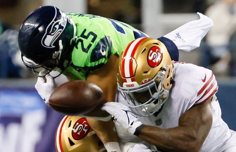 San Francisco 49ers linebacker Dre Greenlaw hits Seattle Seahawks running back Travis Homer as he is tackled by cornerback Charvarius Ward causing a fumble during the second quarter. The 49ers would score a touchdown on the ensuing possession. 222453