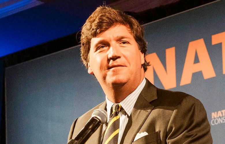 FILE – In this July 15, 2019, file photo, Fox News host Tucker Carlson speaks at the National Conservatism Conference in Washington. Carlson has echoed Russian claims that the invasion of Ukraine was taken in self-defense. He has also criticized Russia’s president, Vladimir Putin.