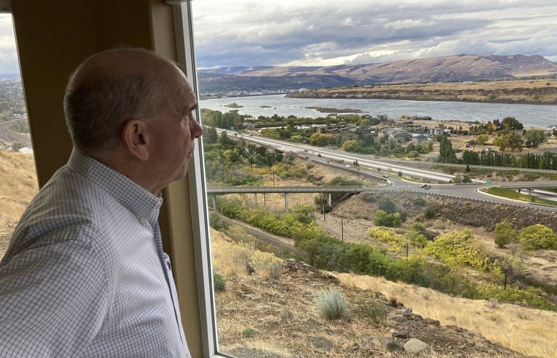 FILE – In this Tuesday, Oct. 5, 2021, photo, The Dalles Mayor Richard Mays looks at the view of his town and the Columbia River from his hilltop home in The Dalles, Ore. Residents of The Dalles should soon know how much of their water Google’s data centers there have been using to cool the computers, after a lawsuit seeking to keep the information confidential was dropped. (AP Photo/Andrew Selsky, File) LA402 LA402