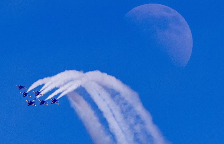 The Blue Angels do a team maneuver during a performance as they fly over Seattle for the 72nd Seafair on Friday Aug. 5, 2022.