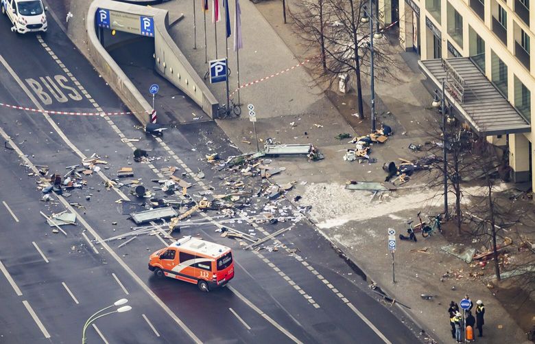 Debris lay in front of a hotel in Berlin, Germany, Friday, Dec. 16, 2022. German police say a huge fish tank in the center of Berlin has burst, causing a wave of devastation in and around the Sea Life tourist attraction. (Christoph Soeder/dpa via AP) DMSC107 DMSC107